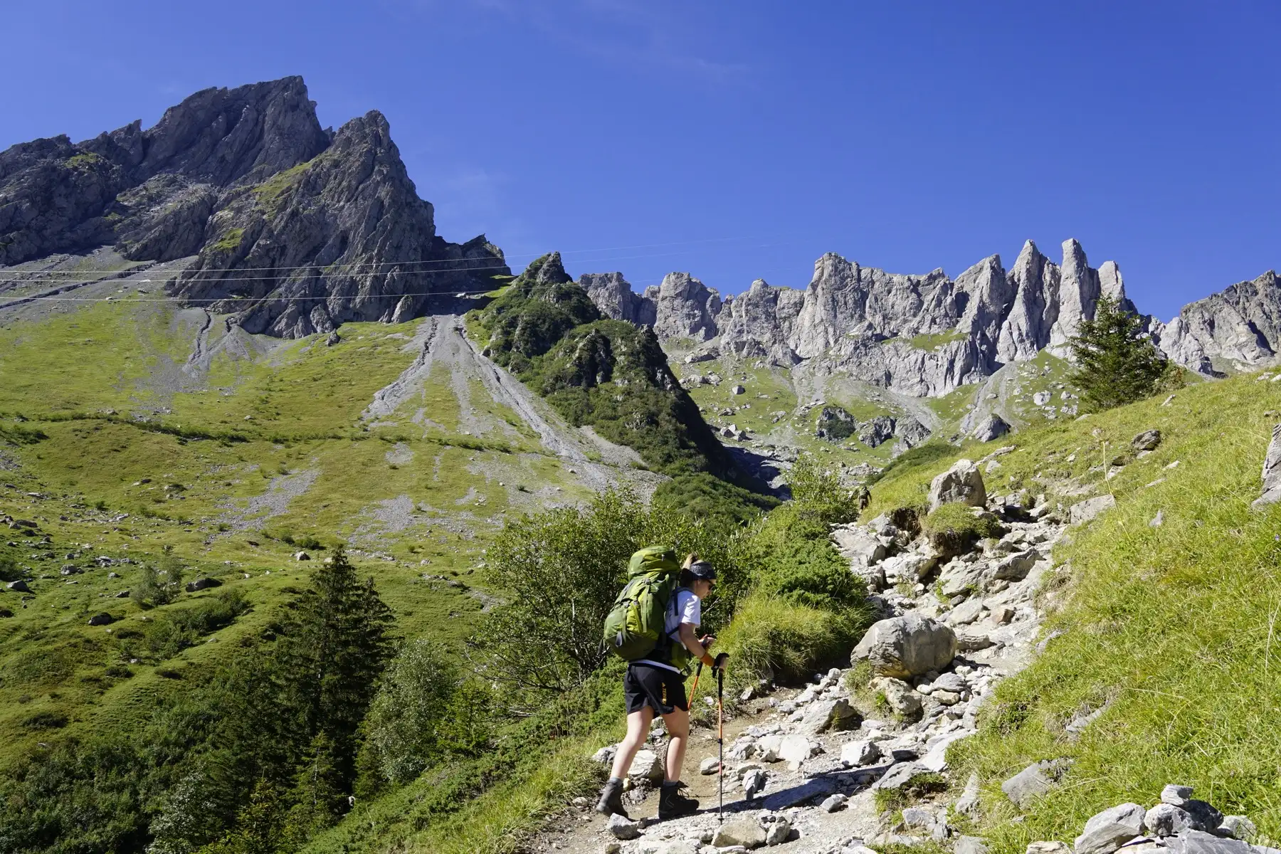 Hiker walking uphill in the mountains